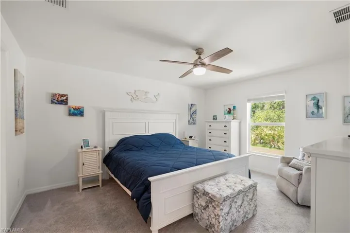 Bedroom with light carpet and ceiling fan