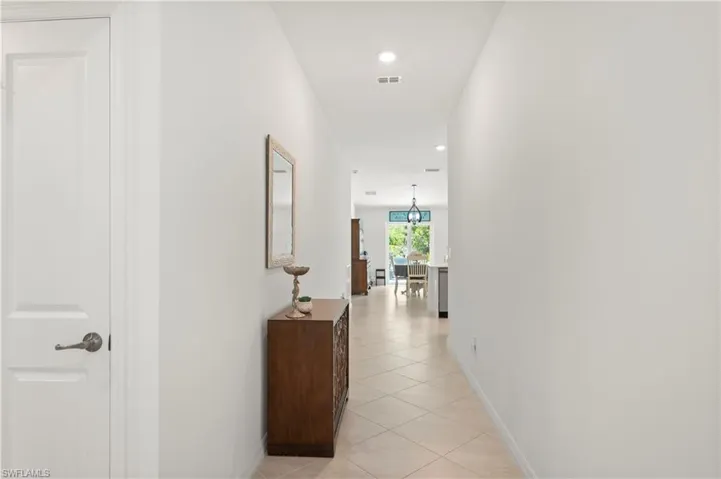 Corridor featuring light tile patterned flooring and recessed lighting