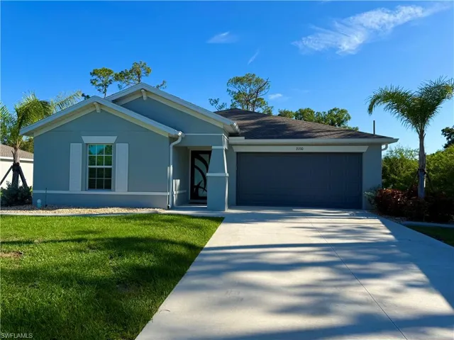 Single story home with stucco siding, a garage, concrete driveway, and a front yard