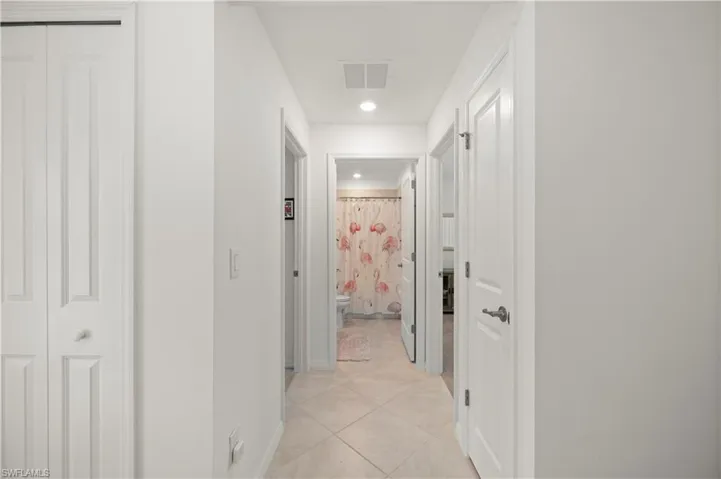 Hallway with recessed lighting and light tile patterned floors