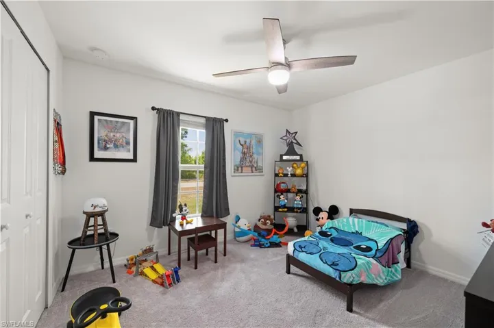 Recreation room with carpet floors and a ceiling fan