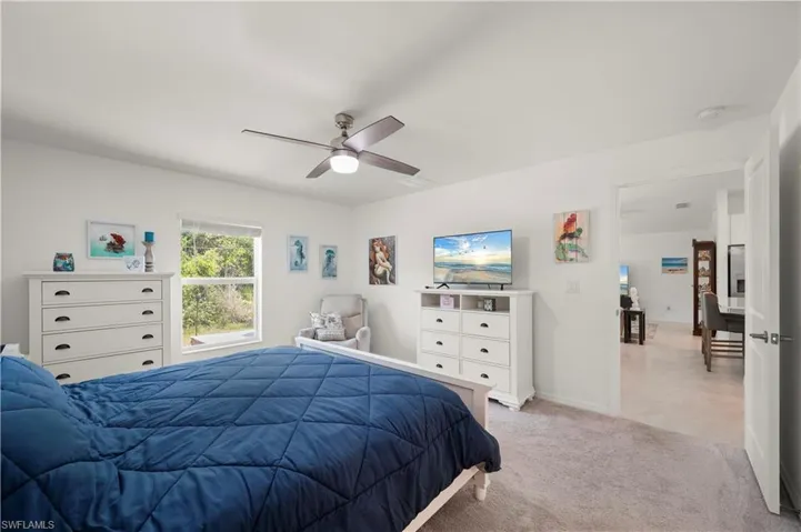 Bedroom with light carpet and ceiling fan