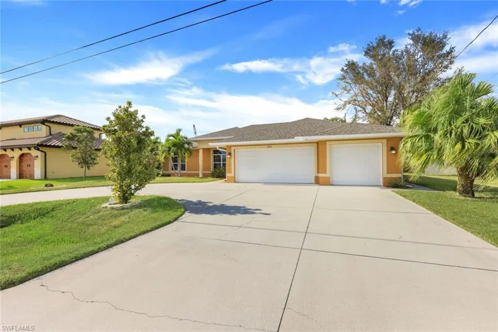 View of front of property with a front yard and a garage