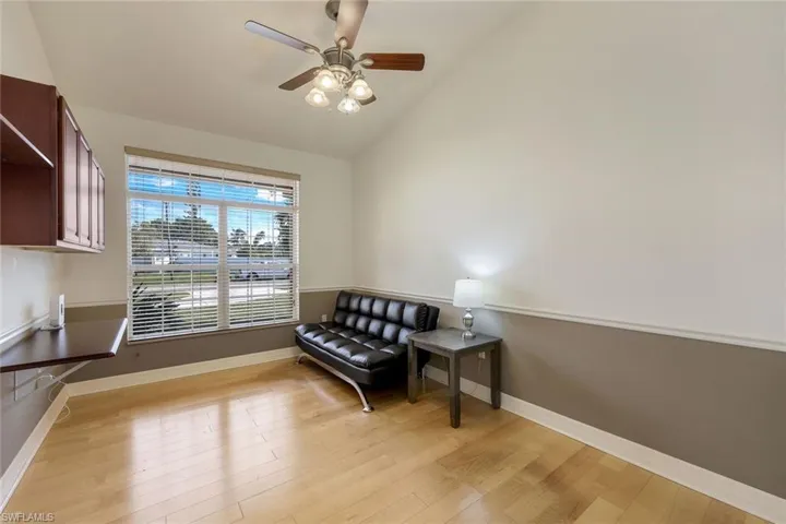 Office featuring vaulted ceiling, light wood-look floors, and ceiling fan