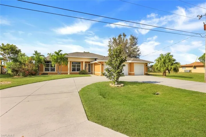 Ranch-style home with a front yard and a garage