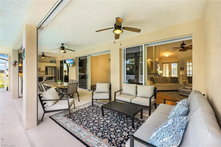 View of patio with outdoor lounge area and ceiling fan