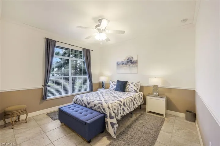 Bedroom with ceiling fan and crown molding