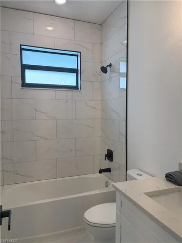 Bathroom with vanity and  shower combination