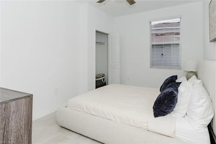 Bedroom with a ceiling fan and light tile patterned floors