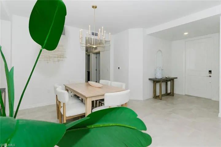 Dining space featuring a chandelier and baseboards