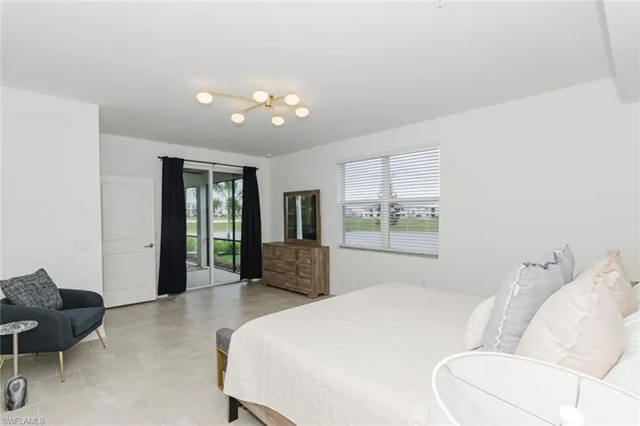 Bedroom with multiple windows and access to exterior
