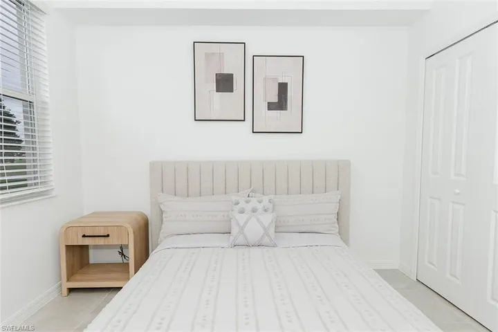 Bedroom featuring light tile patterned floors and a closet