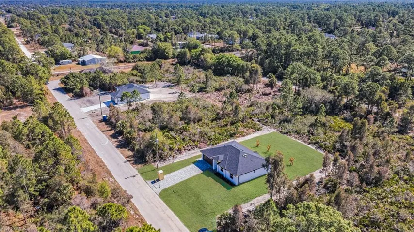View from above of property featuring a heavily wooded area