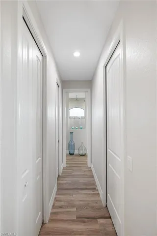 Corridor featuring light wood-type flooring