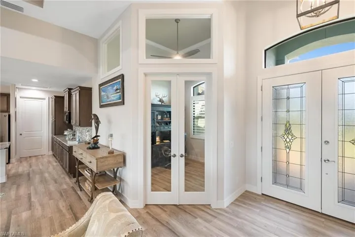 Foyer featuring french doors, light wood-type flooring, and a wealth of natural light
