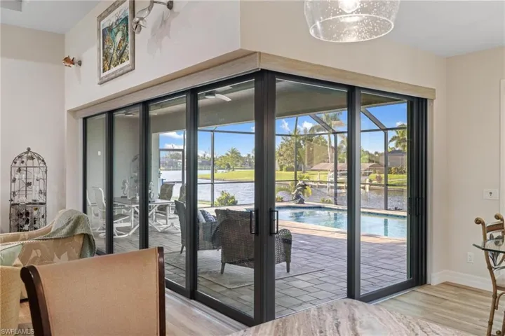Entryway with a water view, light wood-type flooring, and french doors