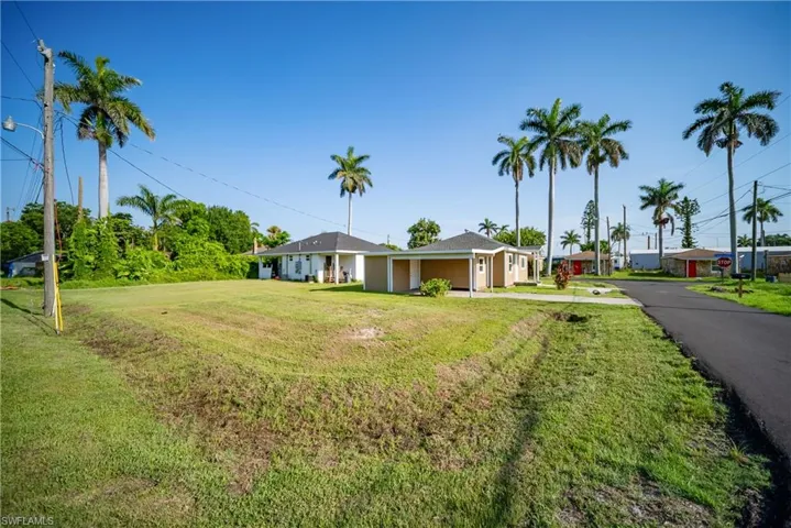 Ranch-style home featuring a front lawn and driveway