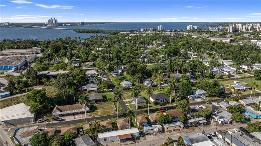 View of property location featuring a large body of water, nearby urban area, and nearby suburban area