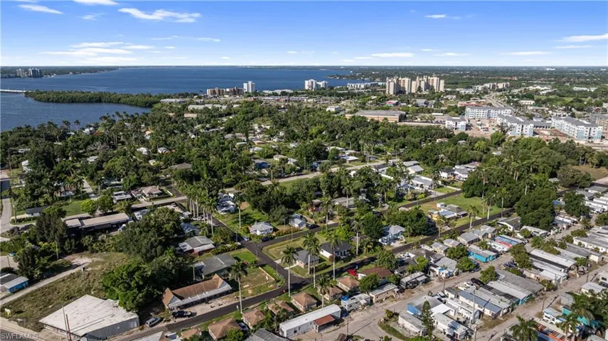 Aerial overview of property's location with a nearby body of water