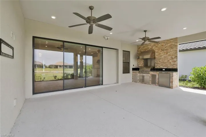 View of patio / terrace featuring exterior kitchen, grilling area, and a ceiling fan