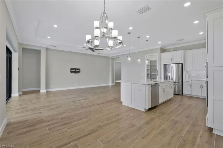 Kitchen with crown molding, a sink, appliances with stainless steel finishes, visible vents, and recessed lighting