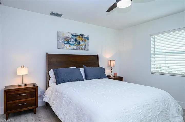 Bedroom with ceiling fan and light hardwood / wood-style flooring