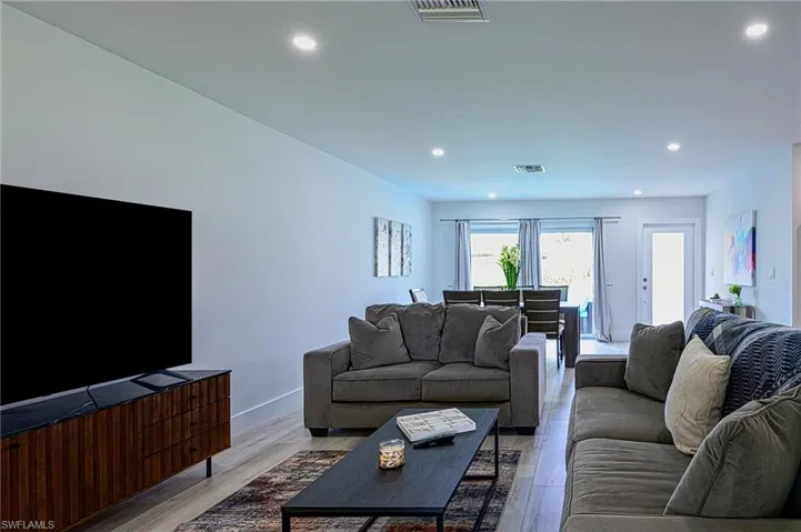 Living room with light hardwood / wood-style flooring