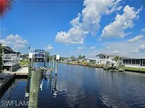 Dock area featuring a water view and boat lift