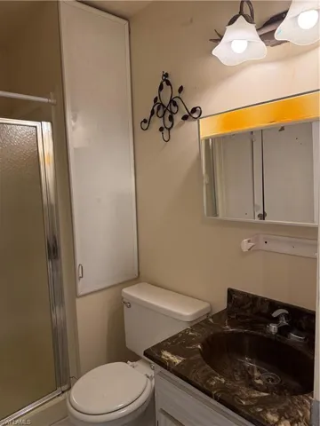 Bathroom featuring vanity and a stall shower