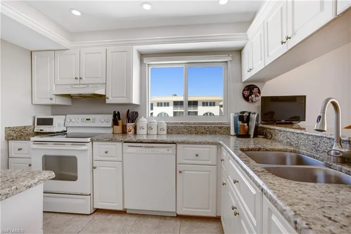 Granite counters, breakfast bar, and plenty of white cabinetry