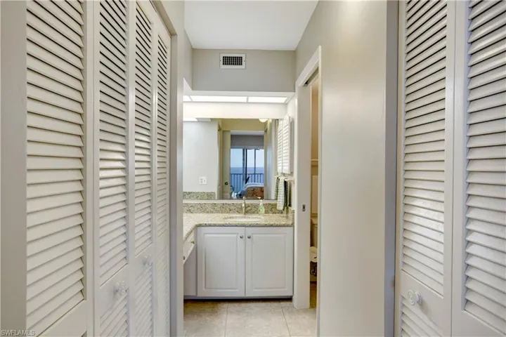 Primary en suite bathroom with additional storage and walk-in closet.