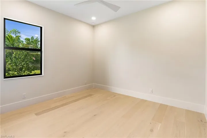 Spare room with wood finished floors and recessed lighting