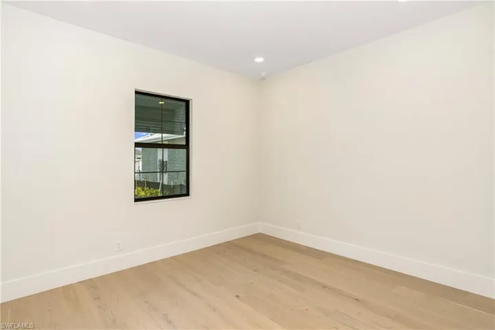 Spare room with light wood finished floors and recessed lighting