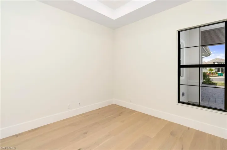Unfurnished room with baseboards and light wood-style flooring