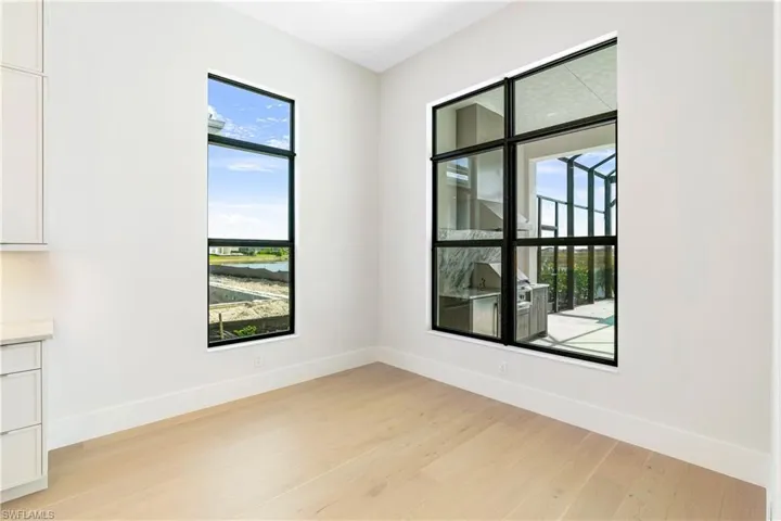 Spare room with light wood-style flooring and baseboards