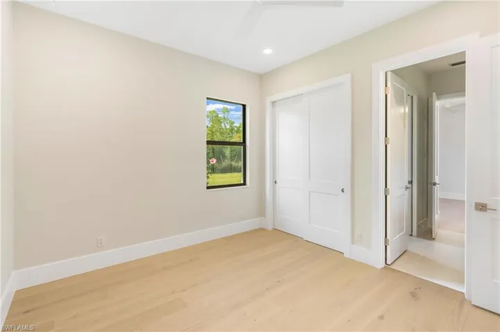 Unfurnished bedroom featuring light wood-style floors, a closet, and ceiling fan