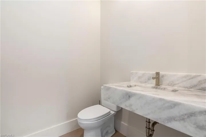 Half bath featuring vanity and toilet