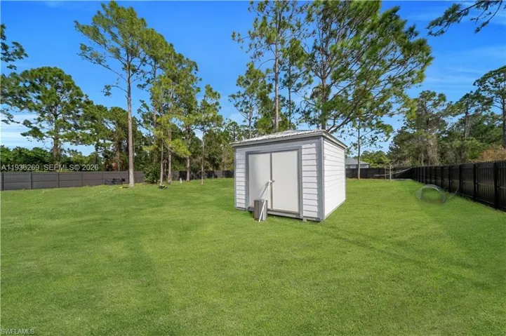 Fenced backyard with a storage shed