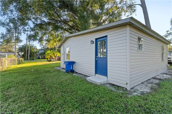 View of outbuilding featuring a yard