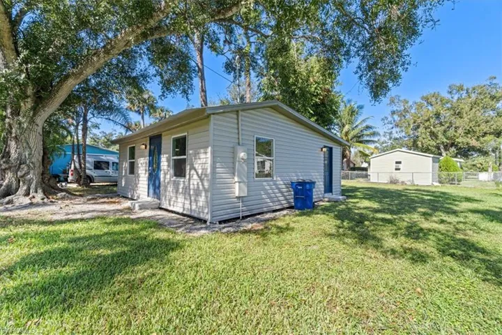 Rear view of house featuring a lawn