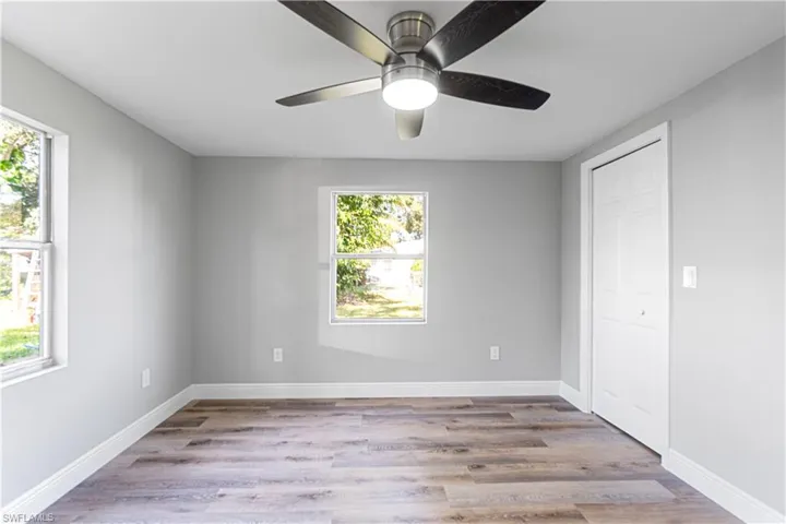 Unfurnished bedroom featuring light hardwood / wood-style flooring and multiple windows