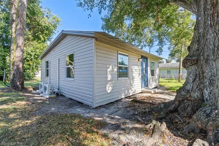 View of side of property featuring ac unit