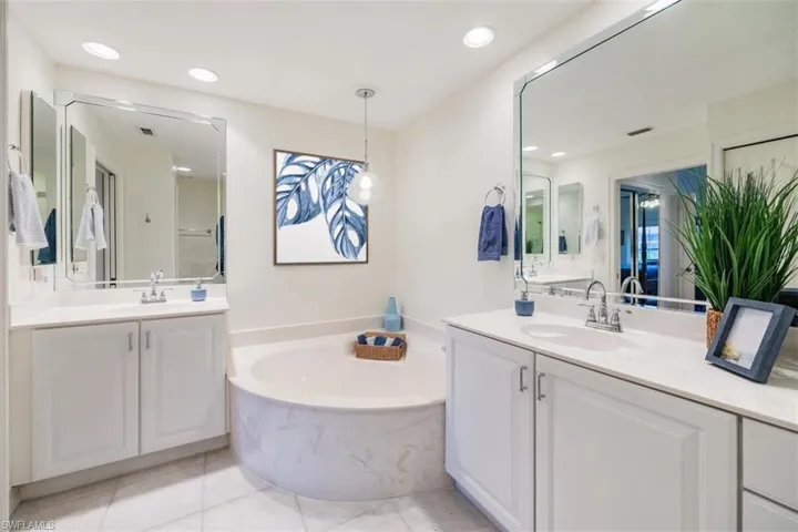 Bathroom featuring a bath, tile patterned flooring, and a sink
