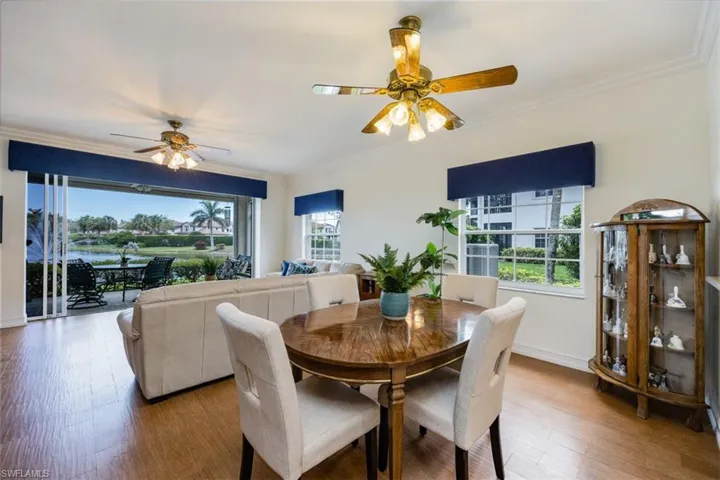 Dining room featuring baseboards, wood finished floors, ceiling fan, and ornamental molding
