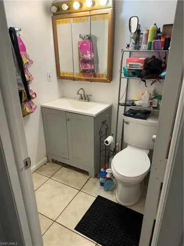 Bathroom with tile patterned floors, toilet, and vanity