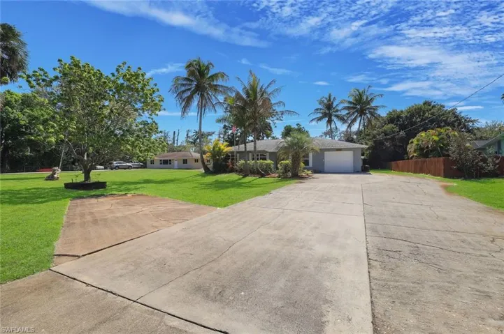 Yard features mature mango, avocado and lychee trees