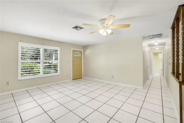 Tile floors and plantation shutter on the window