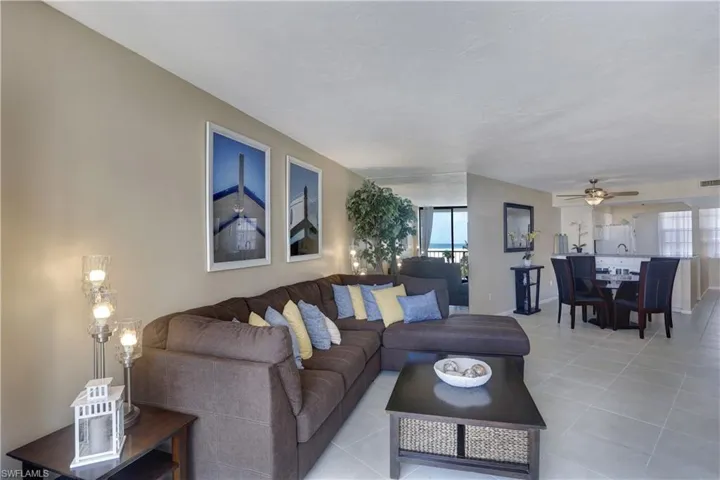 Living room with tile patterned flooring and ceiling fan