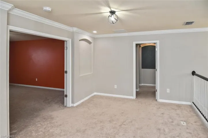 Loft area with crown molding, light carpet, and recessed lighting
