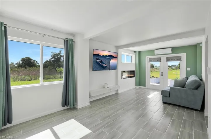 primary bedroom lower level with doors opening to the rear garden